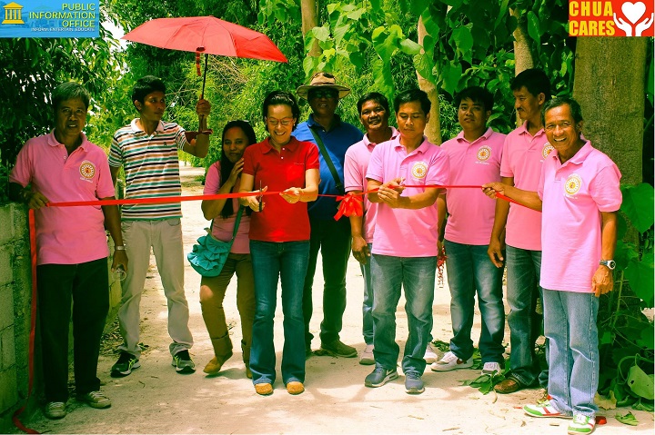 Ceremonial ribbon-cutting of the farm to market road